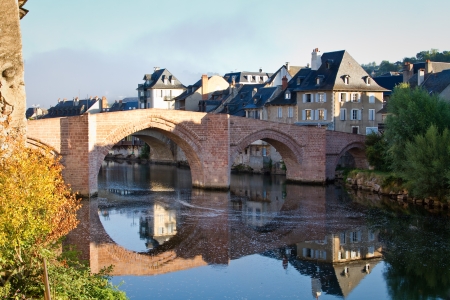 Reflection in the river of Espalion old bridge in Aubrac, Franceの写真素材