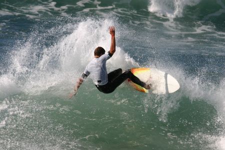 A surfer slashes a turn