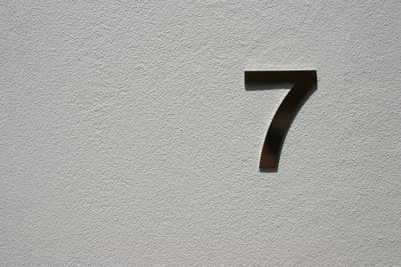 Unit Number 7 on painted concrete background