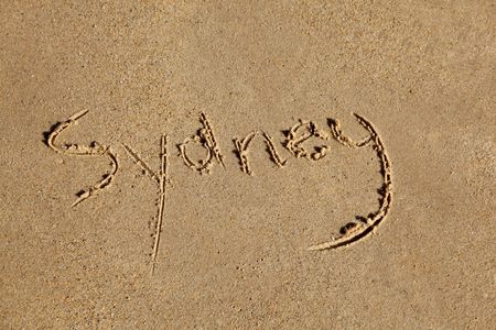 Sydney (Australia's largest city) written in the sand at the beach.の写真素材