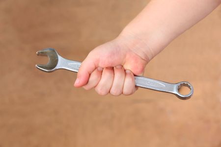 A ring spanner being held in the hand of a young girlの写真素材