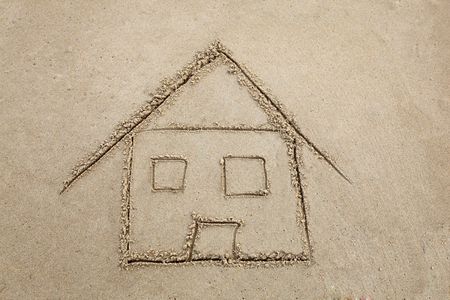 A "beach house" drawn in the sand at the beachの写真素材