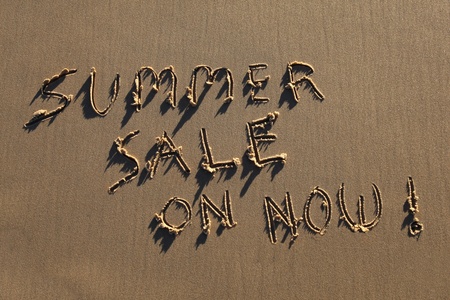 Summer Sale On Now written in the sand at the beach.の写真素材