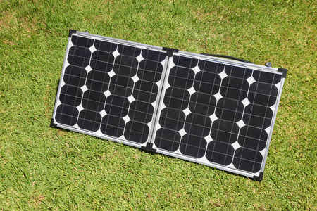 Portable solar panels on green grass  Solar power has become a mainstain of the  glamping  camping recreation  の写真素材