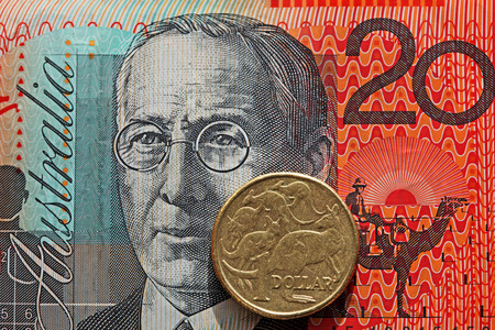 Australian twenty dollar note and one dollar coinの写真素材