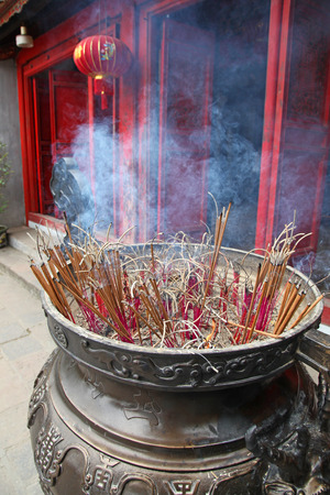 Incense sticks burning in a temple in Hanoi Vietnam.の写真素材
