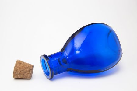 Blue glass bottle with cork on white backgroundの写真素材