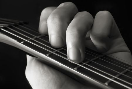 Hand forming chord on guitarの写真素材