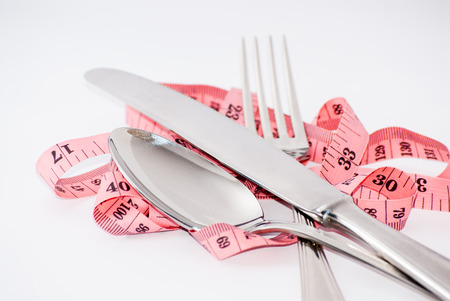 tape-measure fork, knife and spoon isolated whiteの写真素材