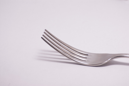 Silver fork and white background isolated shadowの写真素材