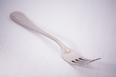 Silver fork and white background. Words verticals transparentの写真素材