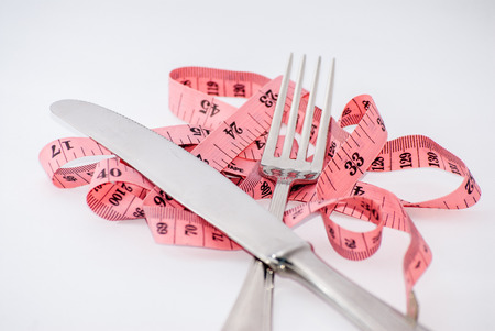 tape-measure fork and knife white background isolatedの写真素材