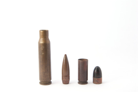 Two bullets isolated white macro rifle and gunの写真素材