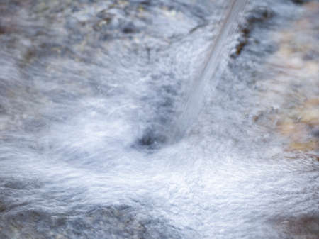 bubbles of water running from a drinking water source in the wild