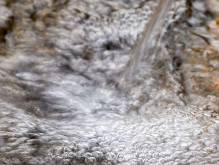 Water flowing from a drinking water source in natureの写真素材