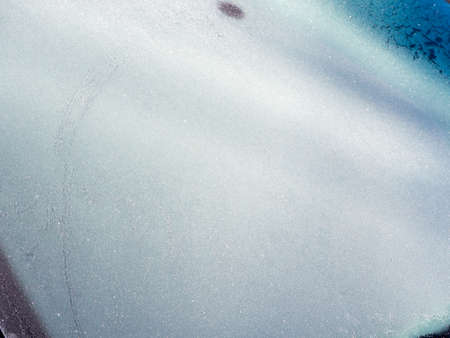 Frozen car on the street on a winter day.