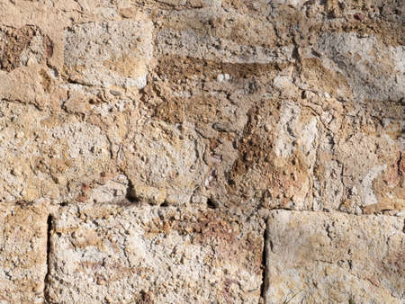 Texture of an old yellow stone wallの写真素材