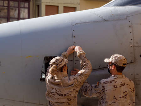 Zamora, Spain - March 20, 2022: Air Force female serviceman handling a fighter plane at a warplane...