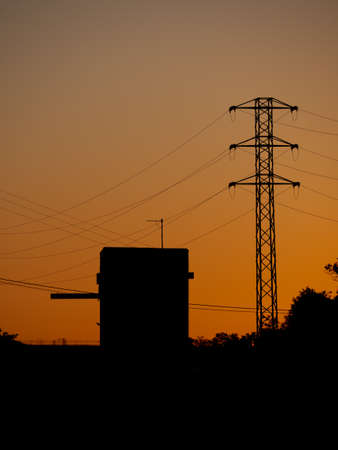 Electricity tower in the light of sunset on a plain. Vertical image. hq photo