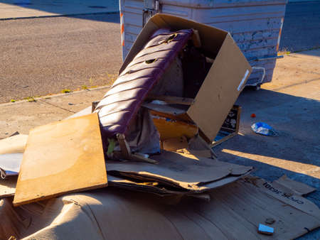 Overflowing garbage container on a street. Recycling conceptの写真素材