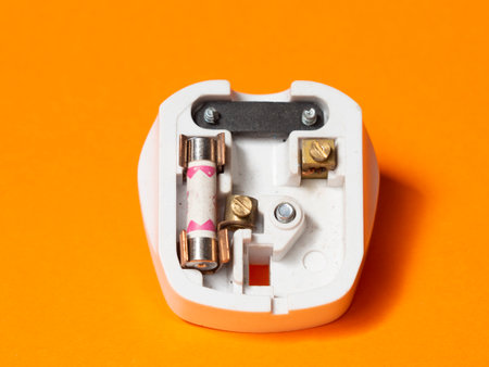 3-pin, 13 amp electrical plug. Engineering concept orange isolatedの写真素材