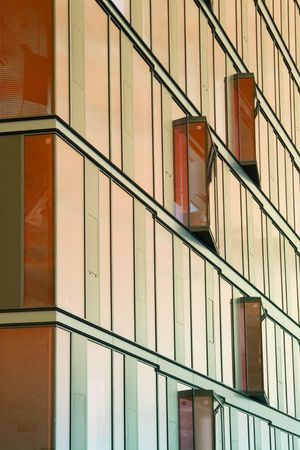close up of modern office building with orange reflection on the windows