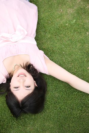 Woman lying on a lawnの写真素材