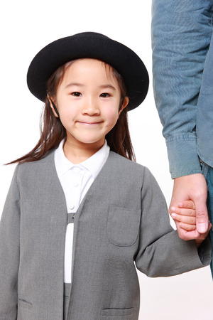 Japanese kindergartener walking to kindergarten with her fatherの写真素材