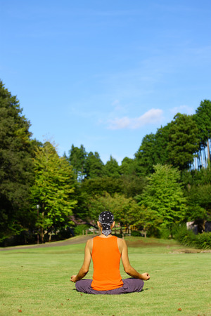 man sitting and meditating calmly aloneの写真素材