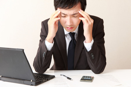 businessman suffers from headache or Asthenopiaの写真素材