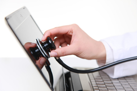 Medical doctor stethoscope examine a computerの写真素材