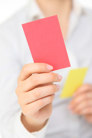 woman showing the red cardの写真素材