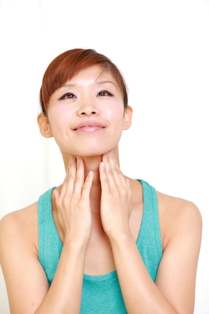 young woman doing self neck massageの写真素材