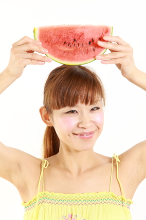 young Japanese woman with watermelonの写真素材