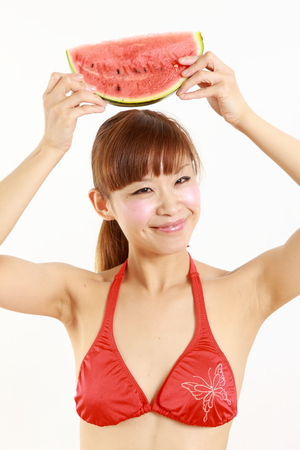 young Japanese woman wearing bikini with watermelonの写真素材