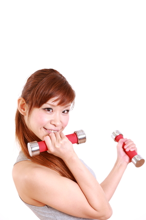 young Japanese woman with dumbbell exercisesの写真素材