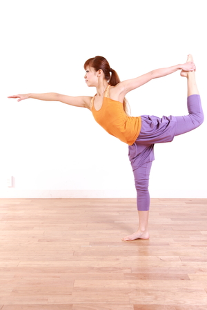 Young Japanese Woman Doing YOGA lord of the dance poseの写真素材