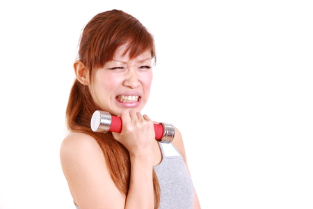 young Japanese woman doing tight trainingの写真素材