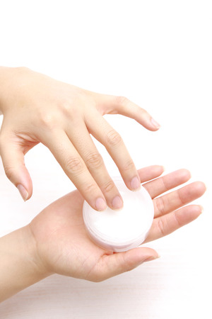 Applying hand cream to handsの写真素材