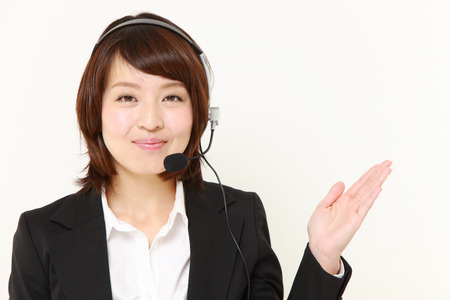 Japanese businesswoman presenting and showing somethingの写真素材