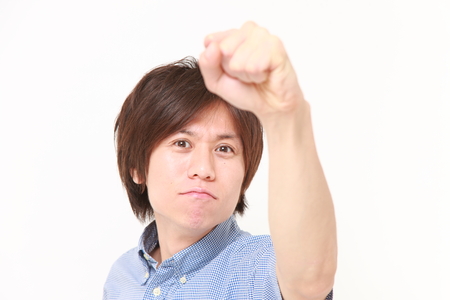 Japanese man in a victory poseの写真素材