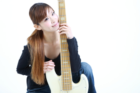 young Japanese woman with 5strings bassの写真素材