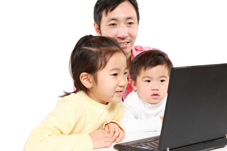 Japanese father and his children on internetの写真素材