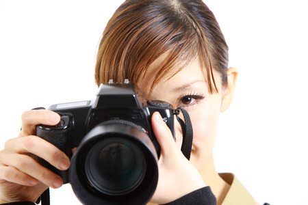 young Japanese woman takes pictureの写真素材