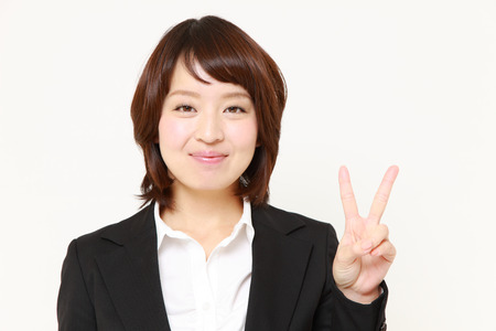 Japanese Businesswoman showing a victory signの写真素材