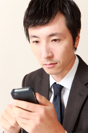 businessman with smart phoneの写真素材