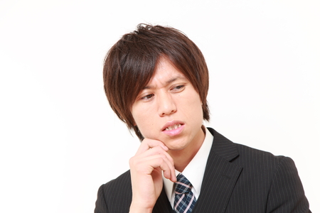young Japanese businessman worries about somethingの写真素材
