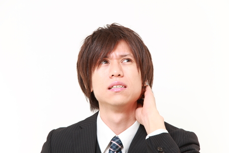 young Japanese businessman worries about somethingの写真素材