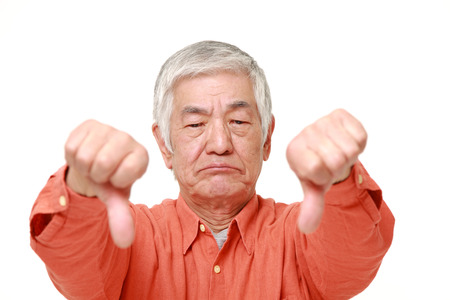senior Japanese man with thumbs down gestureの写真素材