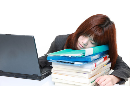 young Japanese businesswoman sleeping on the deskの写真素材